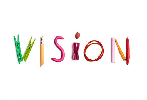 Vision spelled creatively using objects, symbolizing Absolute Academy's focus on innovative test preparation