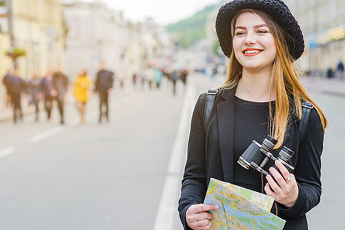 Exploring the benefits of studying abroad, featuring popular destinations and a person with binoculars